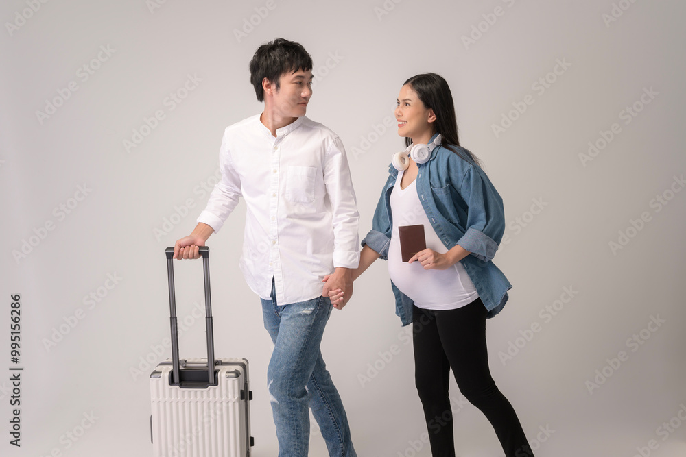 Portrait of Beautiful pregnant woman and husband traveling over white background studio, insurance and maternity concept Portrait of Beautiful pregnant woman and husband traveling over white background studio, insurance and maternity concept