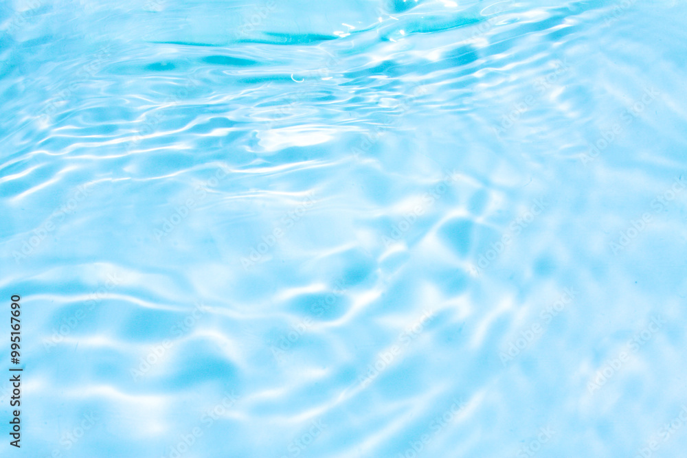 Blue water with ripples on the surface. Defocus blurred transparent blue colored clear calm water surface texture with splashes and bubbles. Water waves with shining pattern texture background. Blue water with ripples on the surface. Defocus blurred transparent blue colored clear calm water surface texture with splashes and bubbles. Water waves with shining pattern texture background.
