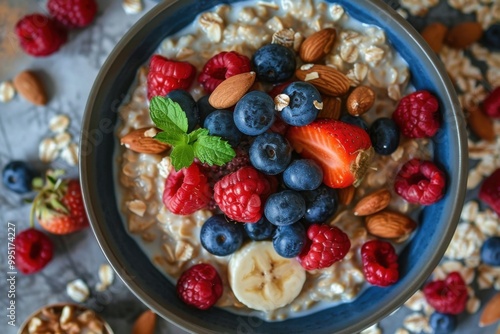 Overhead view of a bowl of oatmeal with berries and nuts on a table, healthy breakfast, detailed and inviting