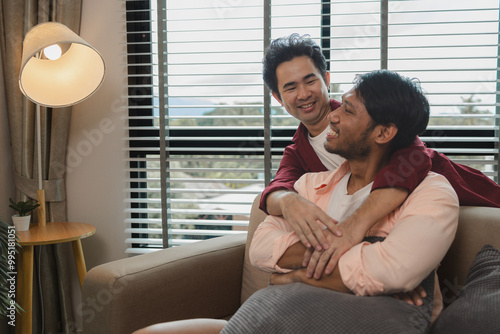 a male couple is spending time together happily in their living room, two handsome guys have a beautiful friendship for a long time, this male couple looks cute together, romantic