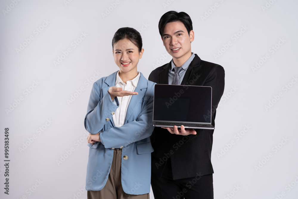Image of an Asian business couple posing on a white background. Image of an Asian business couple posing on a white background.