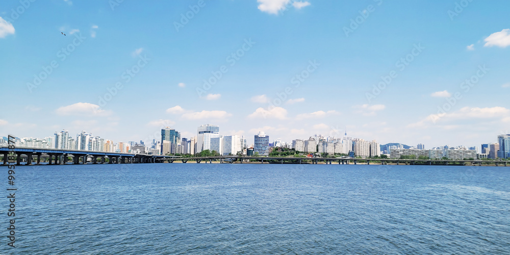 panorama view of the river, Yeouido Hangang River Park, in Seoul, Korea, with a broad bridge, and a cityscape in the backdrop
panorama view of the river, Yeouido Hangang River Park, in Seoul, Korea, with a broad bridge, and a cityscape in the backdrop