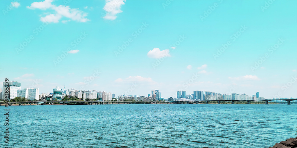 panorama view of the river, Yeouido Hangang River Park, in Seoul, Korea, with a broad bridge, and a cityscape in the backdrop
panorama view of the river, Yeouido Hangang River Park, in Seoul, Korea, with a broad bridge, and a cityscape in the backdrop