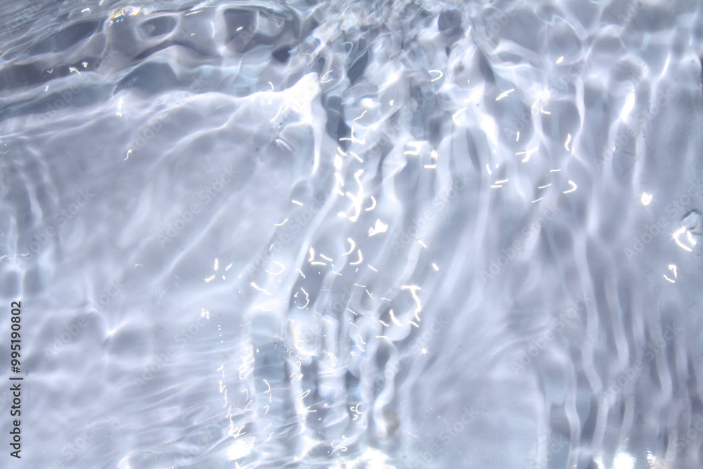 White water with ripples on the surface. Defocus blurred transparent white colored clear calm water surface texture with splashes and bubbles. Water waves with shining pattern texture background. White water with ripples on the surface. Defocus blurred transparent white colored clear calm water surface texture with splashes and bubbles. Water waves with shining pattern texture background.