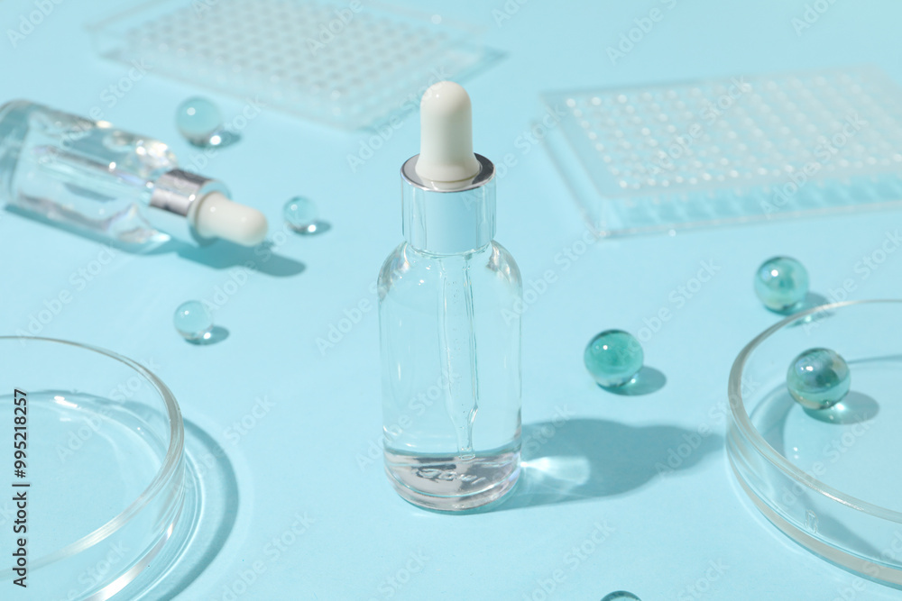 Transparent cosmetic bottles on a blue background Transparent cosmetic bottles on a blue background