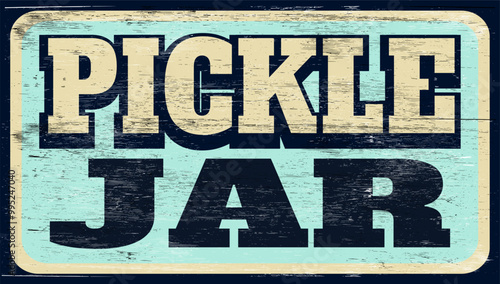 Aged and worn pickle jar sign on wood