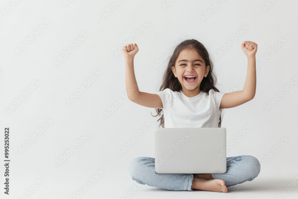 Indian girl sitting on the floor and cheering with her laptop Indian girl sitting on the floor and cheering with her laptop