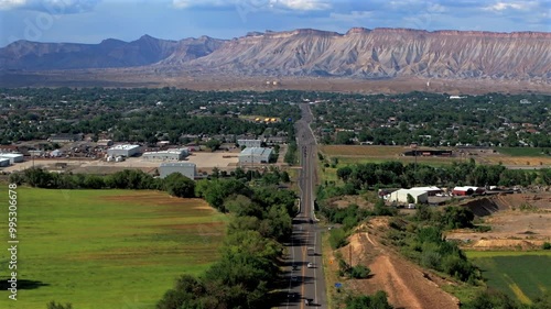 Summer Grand Mesa downtown Main Street Grand Junction Colorado river aerial drone forward pan up motion afternoon cloudy blue sky wine vineyards Parachute Fruitvale Mt Garfield Western Close Delta USA