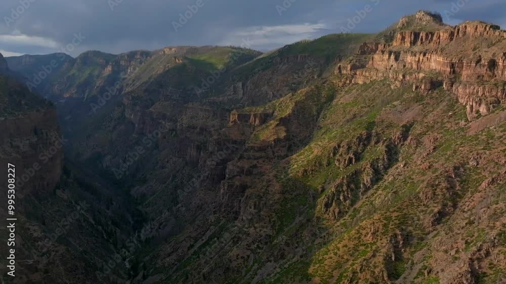 Glenwood Canyon Scenic Drive Glenwood Springs Colorado River summer traffic sun on Grand Mesa cliffside flat top Grizzly Creek fire Bair Ranch late afternoon dark rain thunderstorm cloudy forward pan Glenwood Canyon Scenic Drive Glenwood Springs Colorado River summer traffic sun on Grand Mesa cliffside flat top Grizzly Creek fire Bair Ranch late afternoon dark rain thunderstorm cloudy forward pan