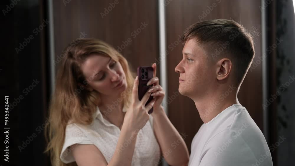 Beautician capturing male client photo using mobile phone prior to eyebrow treatment in comfortable salon, highlighting beauty services and expertise. Handsome man enjoying professional treatment. Beautician capturing male client photo using mobile phone prior to eyebrow treatment in comfortable salon, highlighting beauty services and expertise. Handsome man enjoying professional treatment.