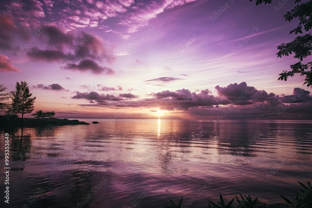 Serene sunset over a calm lake with purple and pink skies. Serene sunset over a calm lake with purple and pink skies.