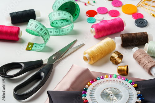 Crafting essentials for sewing projects displayed on a table with fabric, threads, and tools photo