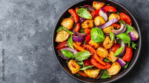 Wallpaper Mural A vibrant salad bowl filled with roasted vegetables including red peppers, onions, and fresh basil, set against a dark stone background. Torontodigital.ca