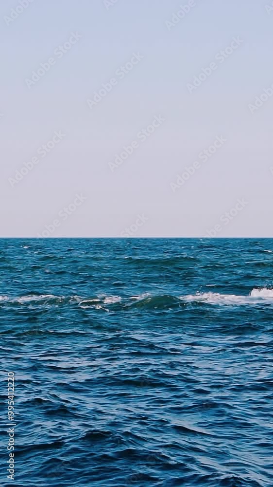 Blue seascape background. Motion of water waves in the sea. Stone dock in seawater. Slow motion. Vertical video Blue seascape background. Motion of water waves in the sea. Stone dock in seawater. Slow motion. Vertical video