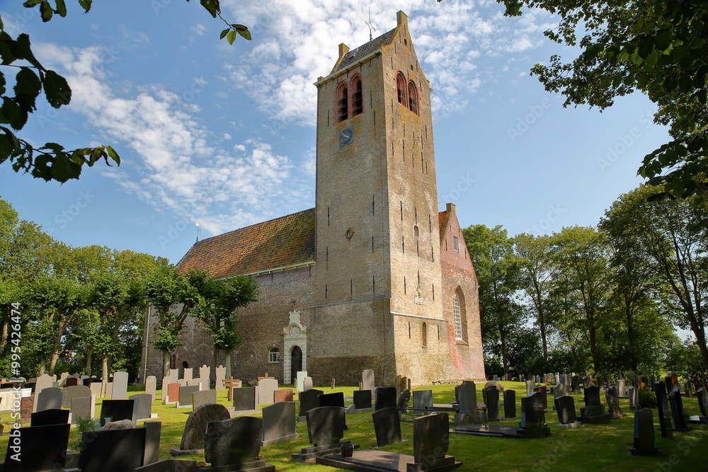 Alexander Church (Alexanderkerk), located in the village Rinsumageest, Friesland, Netherlands, with its clock tower and graveyard