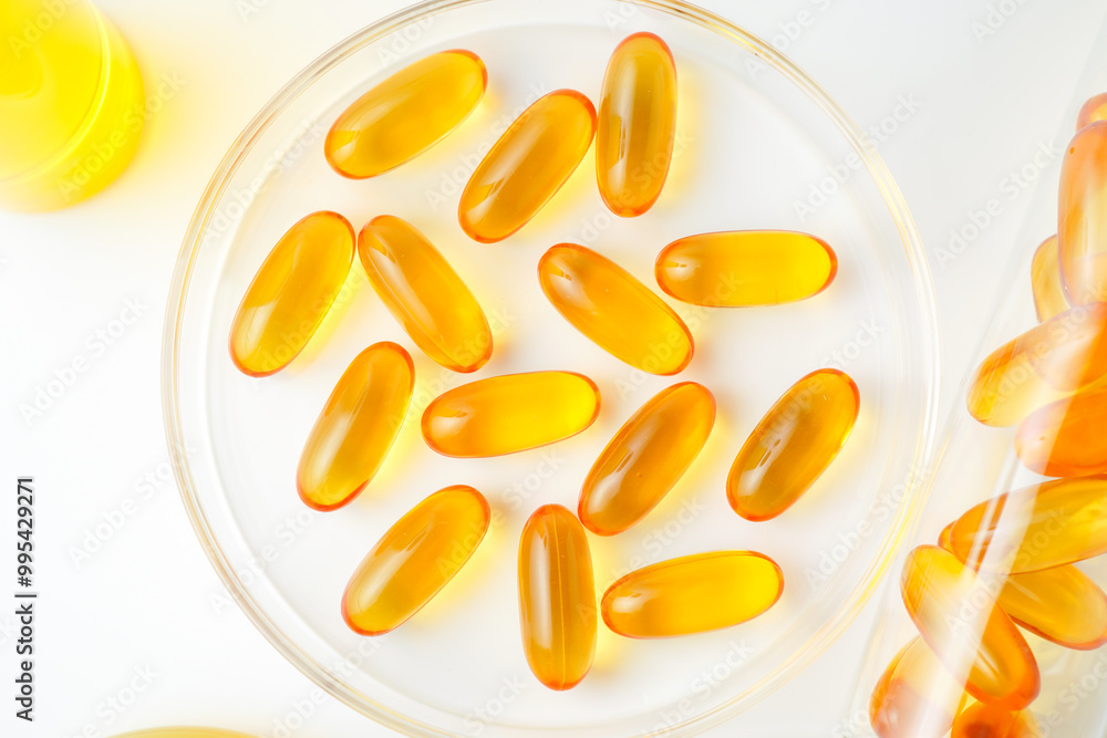 Petri dish with fish oil capsules inside, vitamin D, omega softgels, supplements, keto diet. Petri dish with fish oil capsules inside, vitamin D, omega softgels, supplements, keto diet.