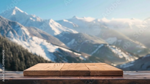 Empty wooden board on table against blurred winter mountain backdrop for product display