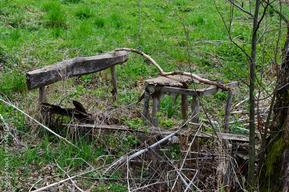 a broken wooden table and a bench a broken wooden table and a bench