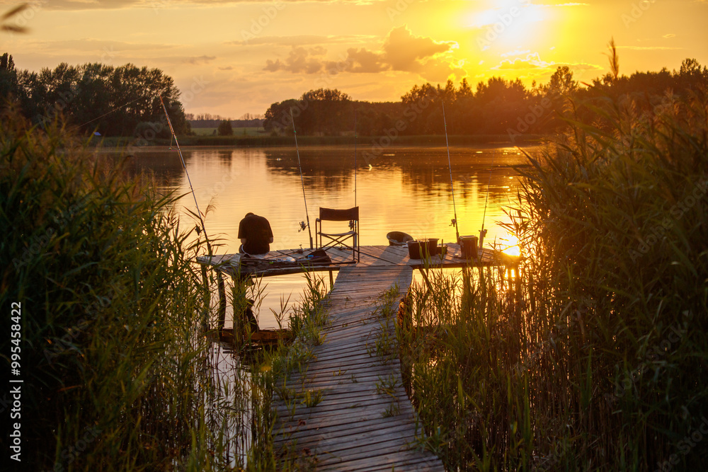 A dock with a chair and a fishing pole A dock with a chair and a fishing pole
