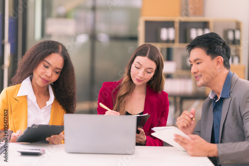 Group of young business people, startup business team from different nationalities meeting in modern office and brainstorming, working on laptops and tablets with financial chart documents.