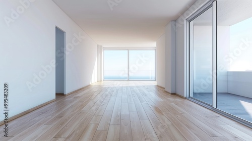 A modern living room features large glass windows that showcase ocean views, allowing natural light to fill the space. The hardwood floors add warmth to the bright, airy atmosphere