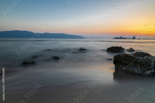 Sunset at beach near the city of Vlorë in Albania, which sprawls on the Bay of Vlorë and is surrounded by the foothills of the Ceraunian Mountains along the Albanian Adriatic and Ionian Sea Coasts photo