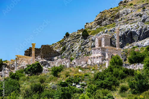 Ancient ruins of the Heroon in Sagalassos ancient city, against a mountainous backdrop on a sunny day. Aglasun, Turkey (Turkiye) photo