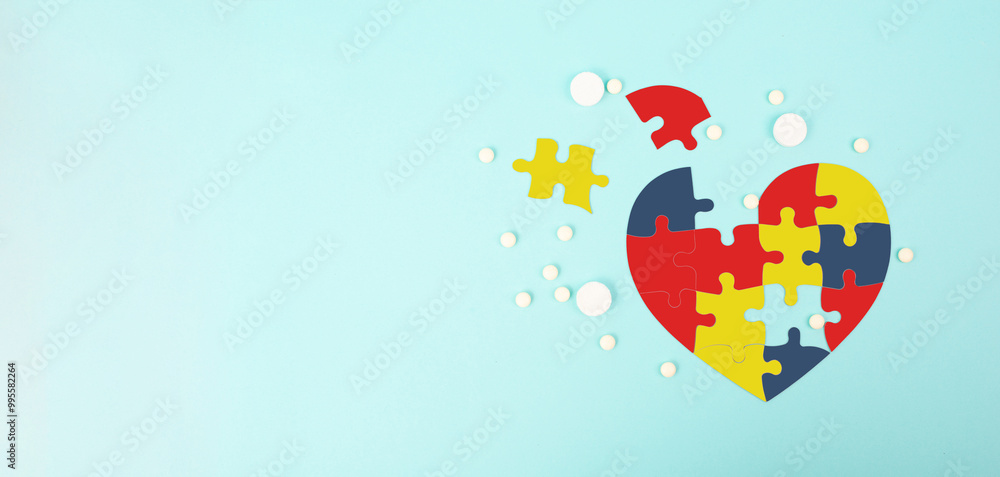ASD autism spectrum disorder, treatment medical pills, deficits in social communication, heart with colorful jigsaw or puzzle pieces ASD autism spectrum disorder, treatment medical pills, deficits in social communication, heart with colorful jigsaw or puzzle pieces