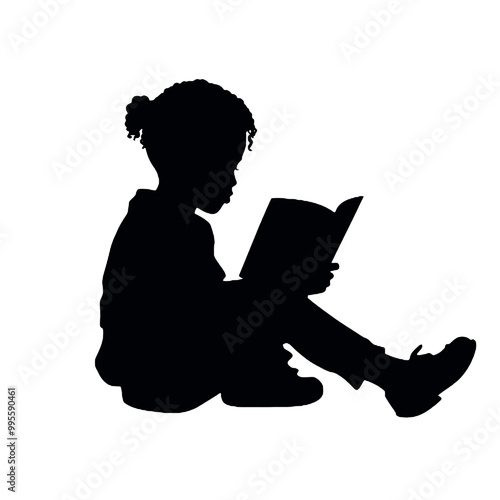 Silhouette of a young person reading a book