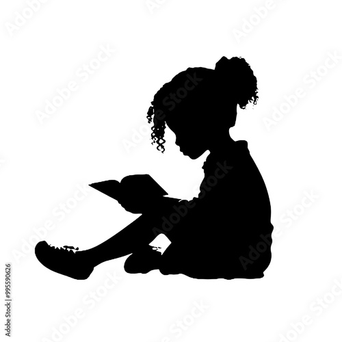 Silhouette of a young person reading a book