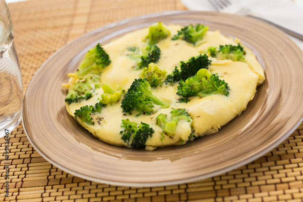 Wholesome breakfast. omelet with broccoli on brown plate Wholesome breakfast. omelet with broccoli on brown plate