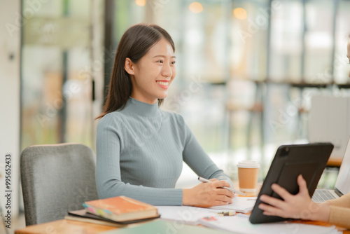 Asian business woman working happily at the office