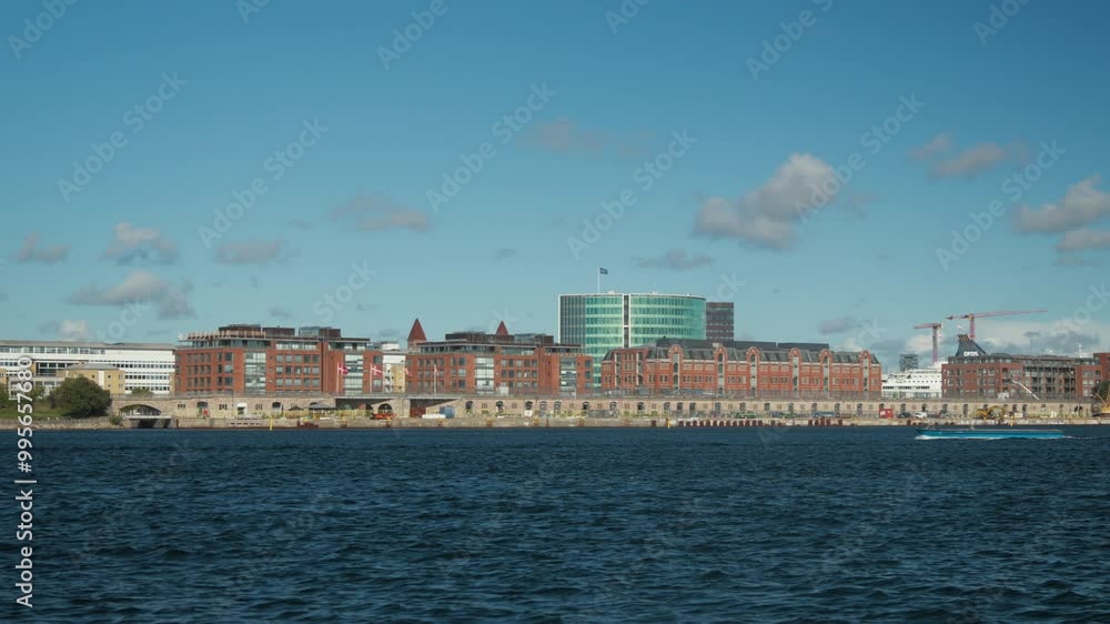 Scenic waterfront skyline of Copenhagen on a sunny day. Ideal for travel promos or architectural documentaries. Scenic waterfront skyline of Copenhagen on a sunny day. Ideal for travel promos or architectural documentaries.