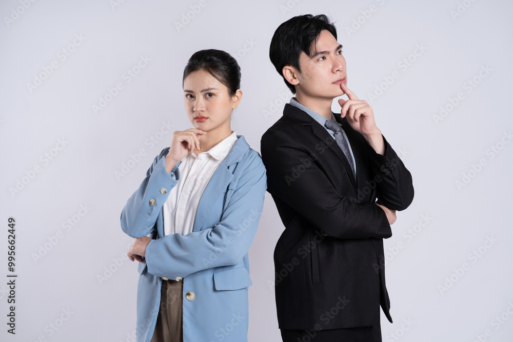 Image of an Asian business couple posing on a white background. Image of an Asian business couple posing on a white background.