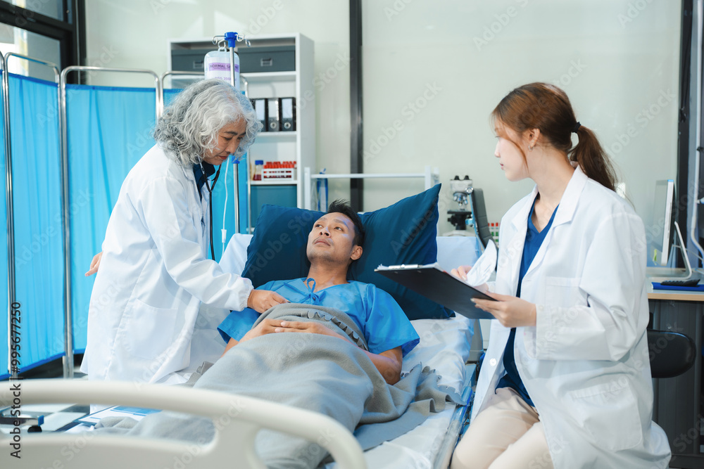 doctor talking with man patient for monitoring and check up after surgery. doctor touching patient hand and consoling. doctor talking with man patient for monitoring and check up after surgery. doctor touching patient hand and consoling.
