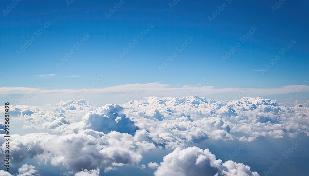 Fototapeta premium bright cloudy sky view from airplane. White clouds on blue sky background close up, cumulus clouds high in azure skies, beautiful aerial cloudscape view from above.