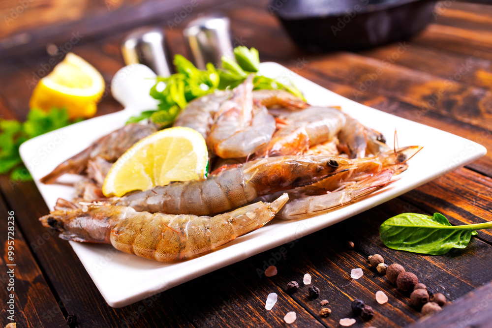 Uncooked Raw peeled tiger white shrimp prawn. Dark background. Uncooked Raw peeled tiger white shrimp prawn. Dark background.
