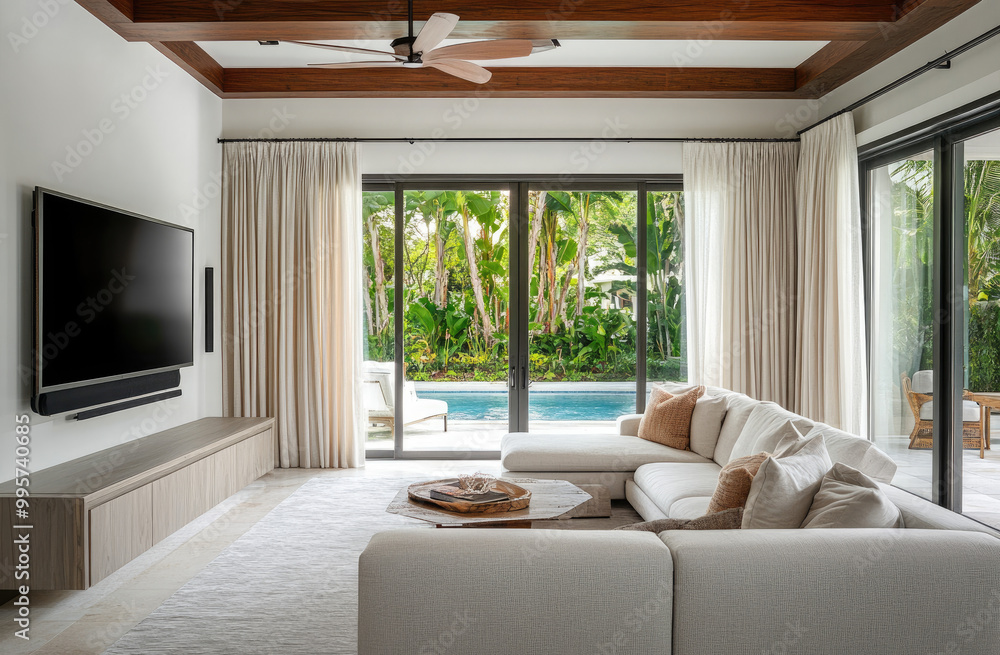 Fototapeta premium A modern and luxurious living room with sliding glass doors leading to the pool in front of it
