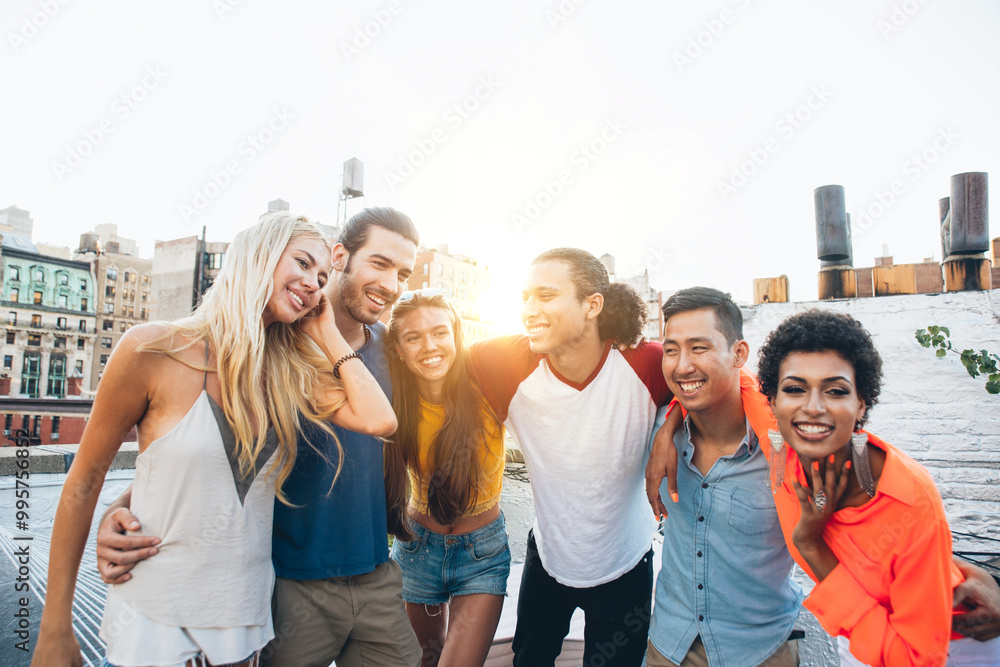 Group of friends spending time together on a rooftop in New york city, lifestyle concept with happy people Group of friends spending time together on a rooftop in New york city, lifestyle concept with happy people