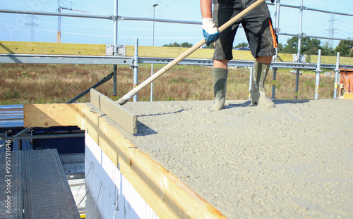 Workers filling the second floor ground with concrete, core and shell construction building  photo