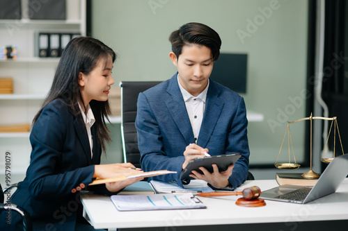 Asian business team and lawyers discussing contract papers sitting at the table. Concepts of law, advice, legal services.