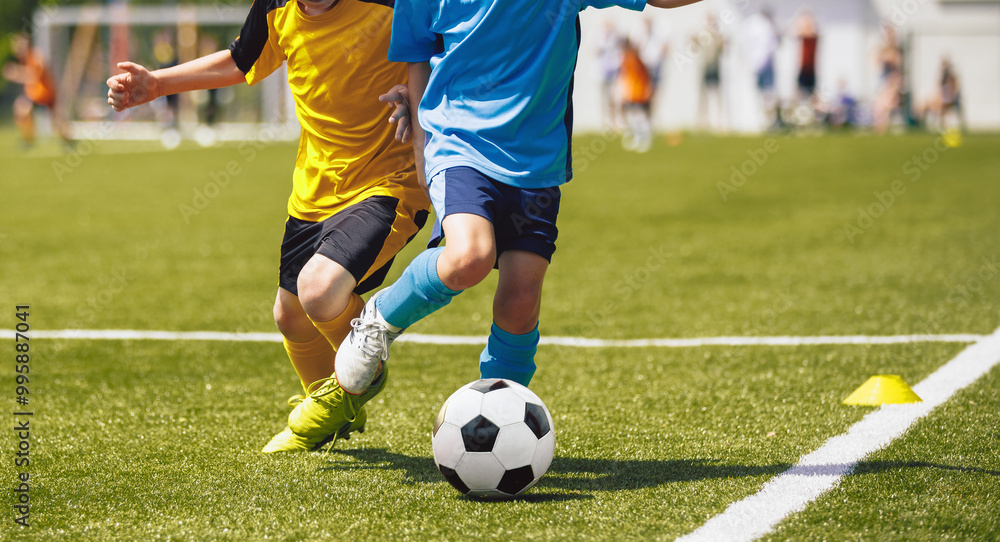 Boys Kicking Football Ball. Children Play Soccer on Grass Field. Spectators Parents in the Background. Youth Players kicking Soccer Match on grass Stadium. Youth Football Tournament Boys Kicking Football Ball. Children Play Soccer on Grass Field. Spectators Parents in the Background. Youth Players kicking Soccer Match on grass Stadium. Youth Football Tournament