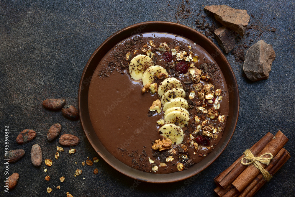 Chocolate banana smoothie bowl with granola. Top view with copy space. Chocolate banana smoothie bowl with granola. Top view with copy space.