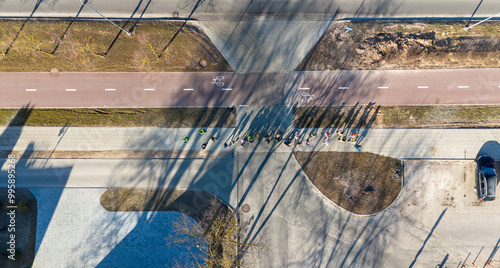Aerial view of road with cars and children walking on a sidewalk