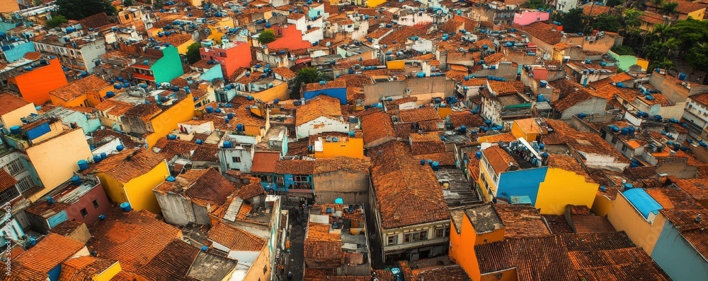 A vibrant aerial view of a colorful urban neighborhood showcasing a mix of rooftops and brightly painted walls. A vibrant aerial view of a colorful urban neighborhood showcasing a mix of rooftops and brightly painted walls.