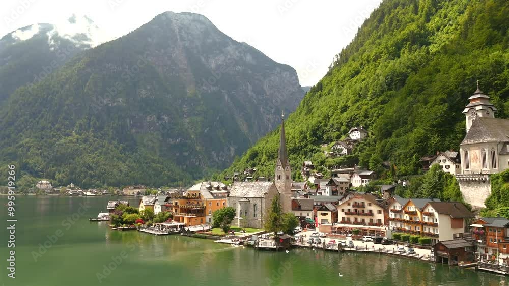 Aerial view of Hallstatt, Austria, captured by drone, showcasing its picturesque lakeside homes, majestic mountains, and the unique charm of this enchanting alpine village. Aerial view of Hallstatt, Austria, captured by drone, showcasing its picturesque lakeside homes, majestic mountains, and the unique charm of this enchanting alpine village.