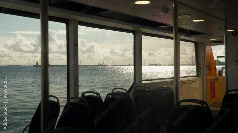 Tranquil ferry ride with scenic sea and windmill views. Perfect for travel documentaries and tourism ads. Tranquil ferry ride with scenic sea and windmill views. Perfect for travel documentaries and tourism ads.