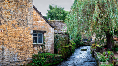 Bourton-on-the-Water is only 4 miles from
Stow-on-the-Wold and straddles the river Windrush with its series of elegant low bridges beside neat tree-shaded greens and tidy stone banks.