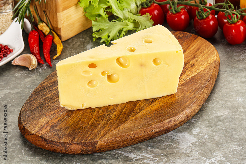 Swiss Maasdam cheese triangle over board Swiss Maasdam cheese triangle over board