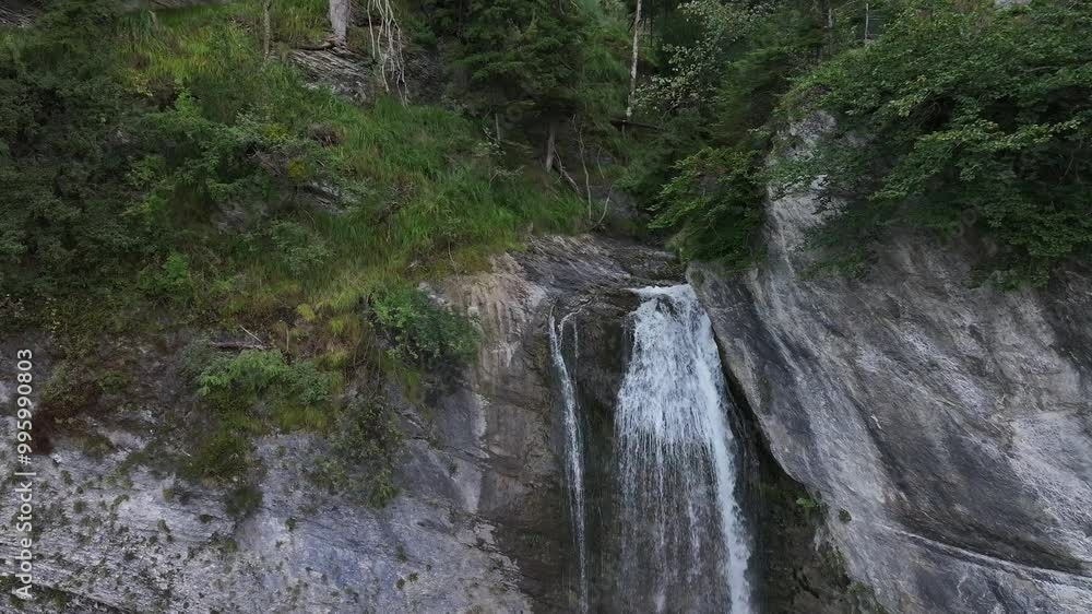 Close-up drone shot of a waterfall flowing into the valley of Canton St. Gallen. It is popular for hiking, sailing and recreational activities Close-up drone shot of a waterfall flowing into the valley of Canton St. Gallen. It is popular for hiking, sailing and recreational activities